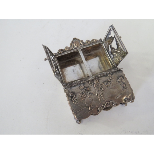 1101 - A Continental silver miniature dressing table with mirror. Two Continental repousse silver miniature... 