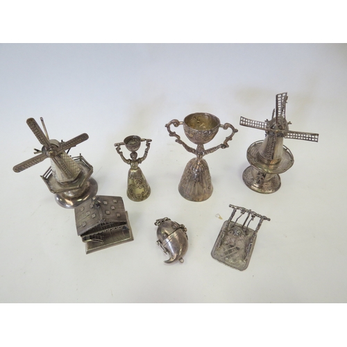 1103 - Seven Continental silver and white-metal miniature novelties including two Dutch windmills, two figu... 