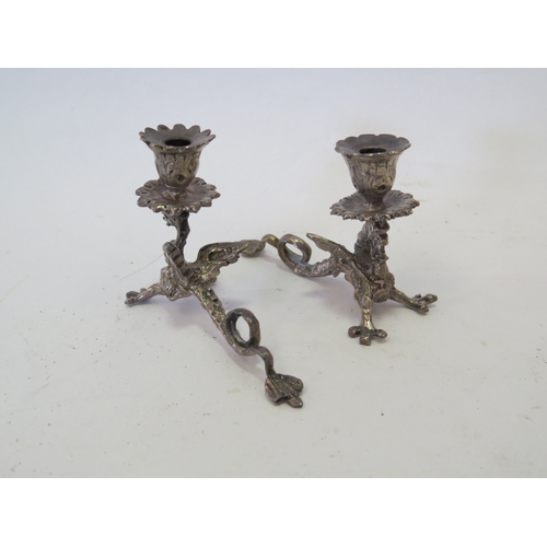 1104 - An Edwardian silver miniature pedestal paten London 1902 and a miniature pepperette as a Jersey milk... 