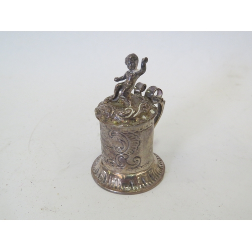 1104 - An Edwardian silver miniature pedestal paten London 1902 and a miniature pepperette as a Jersey milk... 