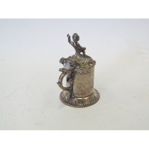 1104 - An Edwardian silver miniature pedestal paten London 1902 and a miniature pepperette as a Jersey milk... 