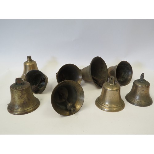 1085 - A quantity of brass bells, with and without clappers, including two with hanging fixings; hand-bells... 