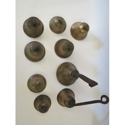 1085 - A quantity of brass bells, with and without clappers, including two with hanging fixings; hand-bells... 