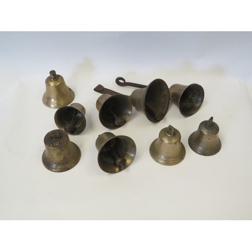 1085 - A quantity of brass bells, with and without clappers, including two with hanging fixings; hand-bells... 