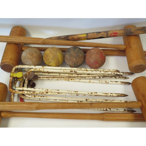 1095 - A croquet set, partially refurbished incl. four wooden mallets and balls, six hoops, with centre pin... 