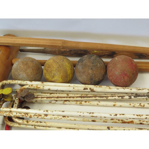 1095 - A croquet set, partially refurbished incl. four wooden mallets and balls, six hoops, with centre pin... 