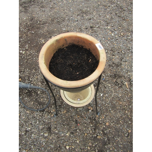 3457 - A metal pot stand and three glazed pots