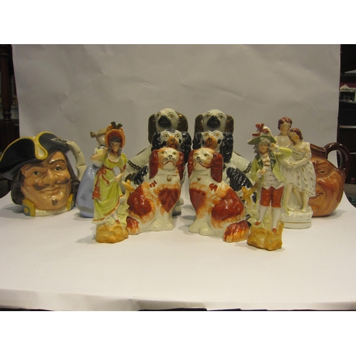 4441 - Four figures including Nao, three pairs of Staffordshire dogs and two Royal Doulton character jugs (... 