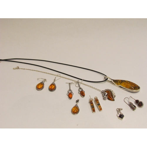 4404 - Four pairs of amber earrings, one pair with matching pendant, an amber and silver horse head pendant... 