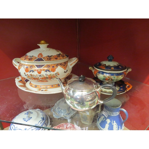 4327 - A lidded tureen on stand decorated with floral scroll swags, a vegetable tureen in dark blue and gil... 