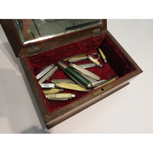 4431 - A marquetry jewellery box with mirror to interior containing various penknives and a Winship Luggage... 