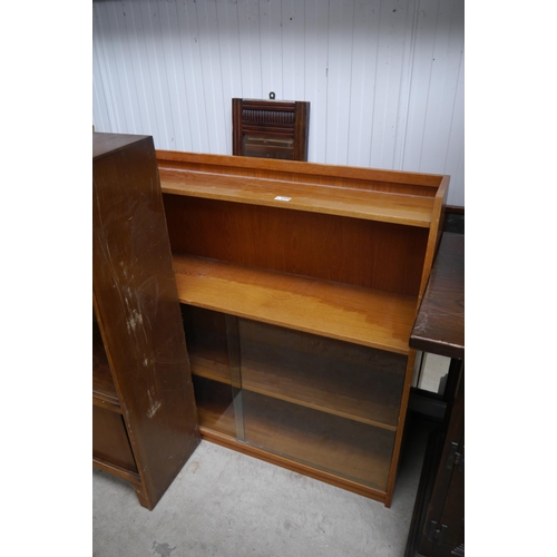 2384 - An 1950's oak bookcase with sliding glass doors