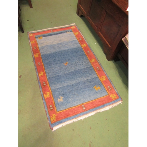 4003 - A blue and terracotta ground rug, 130cm x 75cm  (R)  £15