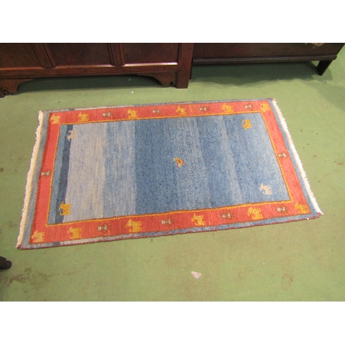 4003 - A blue and terracotta ground rug, 130cm x 75cm  (R)  £15