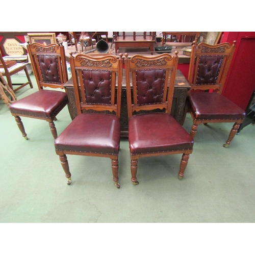 4009 - A set of four oak leather seated and button back dining chairs on castors with carved details