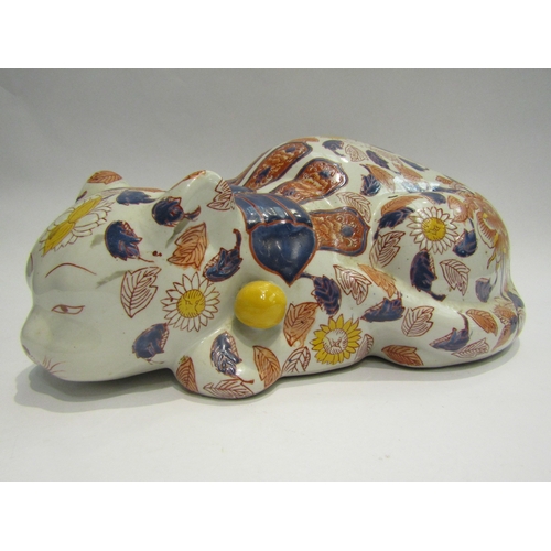 4013 - A Japanese ceramic recumbent cat, floral detailing, 32cm long