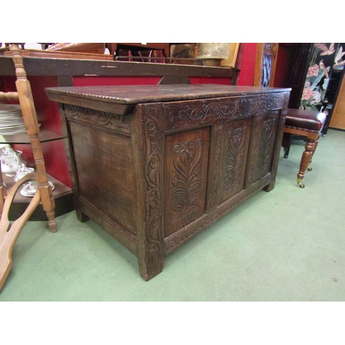 4025 - A late 17th  / early 18th Century carved oak panelled coffer with altered top (split), foliate front... 