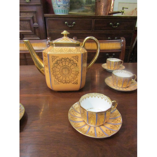 4069 - A peach ground gilt decorated part tea set comprising of teapot, ten cups and ten saucers