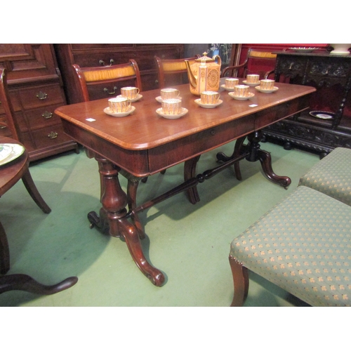 4070 - A rosewood round cornered chamfered edge top library table, the two frieze drawers with 