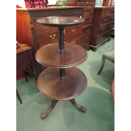 4074 - A mahogany three tier circular whatnot on tripod legs and ball and claw feet