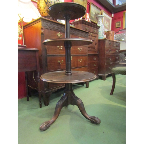 4074 - A mahogany three tier circular whatnot on tripod legs and ball and claw feet