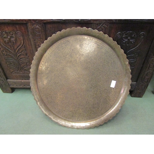 4075 - An Eastern brass tray with frilled edge, 60cm diameter