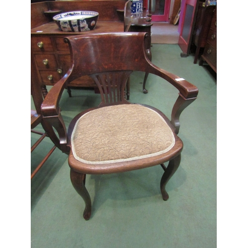 4081 - A circa 1900 oak desk chair, the scroll top backrest with fretwork, central splat over cabriole fore... 