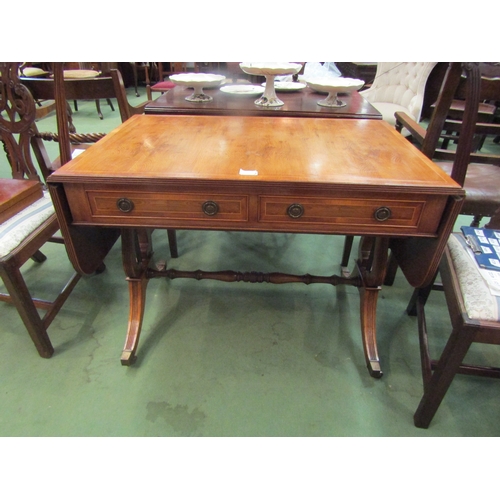 4116 - A yew drop-leaf hall table, lyre form supports, two drawers, on brass castors     (E) £30-40