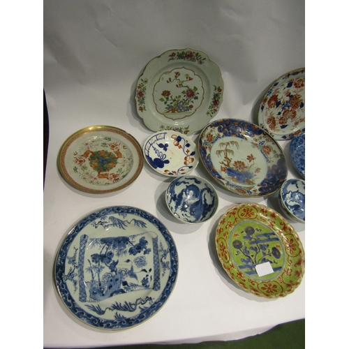 4129 - A quantity of Oriental plates and bowls to include scallop edge plate decorated in blue/green and or... 