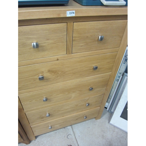 2376 - A modern oak two over four chest of drawers