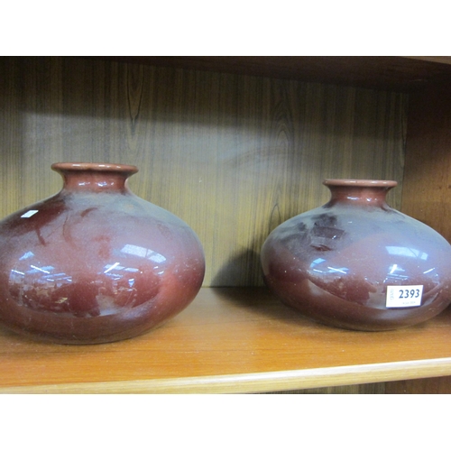 2393 - A pair of Burmantofts style vases, richly glazed