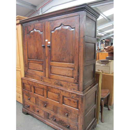 2447 - An 18th Century full height housekeeper's cupboard, twin panelled doors over a five drawer base, rai... 