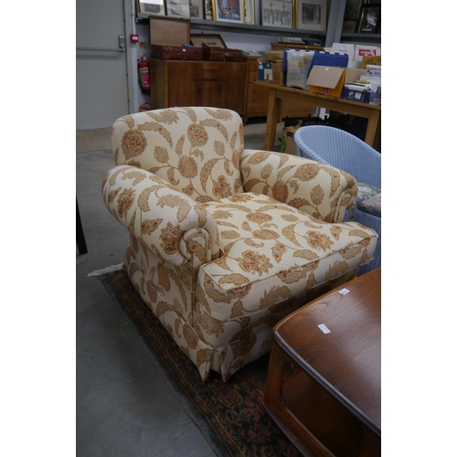 2340 - A deep seated upholstered armchair on castors   (E) £10-20