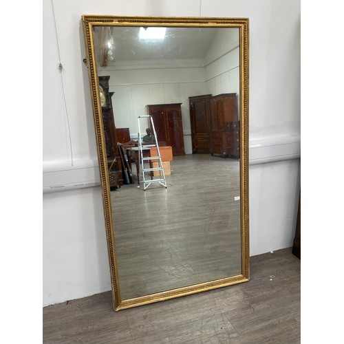 6048 - A gilt pier mirror, some gesso missing, 179cm x 99cm