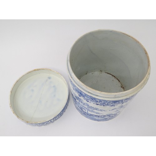 6070 - A blue and white semi-china lidded canister, hairline crack to lid, chip to base, 21.5cm tall x 18.5... 