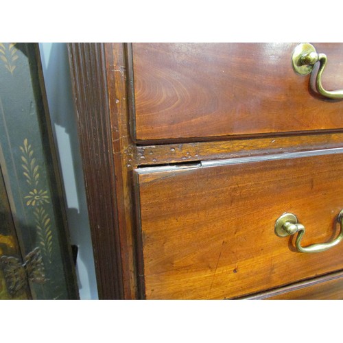 6075 - A George III mahogany chest on chest with brushing slide, areas of damage present to drawer edges,  ... 