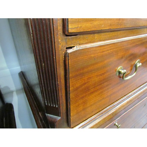 6075 - A George III mahogany chest on chest with brushing slide, areas of damage present to drawer edges,  ... 