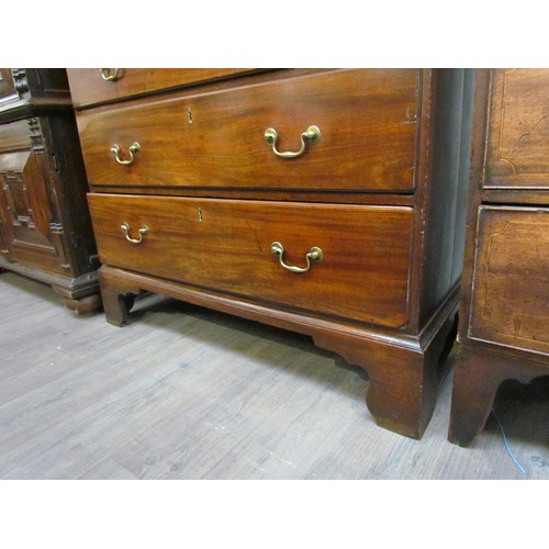 6075 - A George III mahogany chest on chest with brushing slide, areas of damage present to drawer edges,  ... 