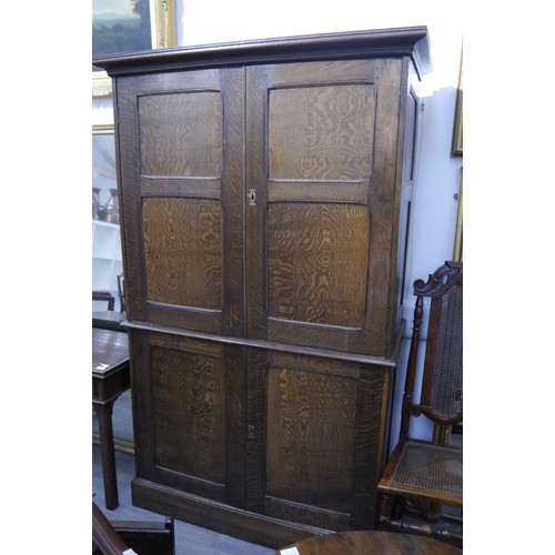 6053 - A 19th Century figured oak house keeper's cupboard with four doors, shelved interior, 196cm x 120cm ... 