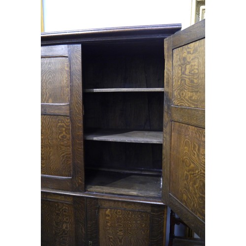 6053 - A 19th Century figured oak house keeper's cupboard with four doors, shelved interior, 196cm x 120cm ... 