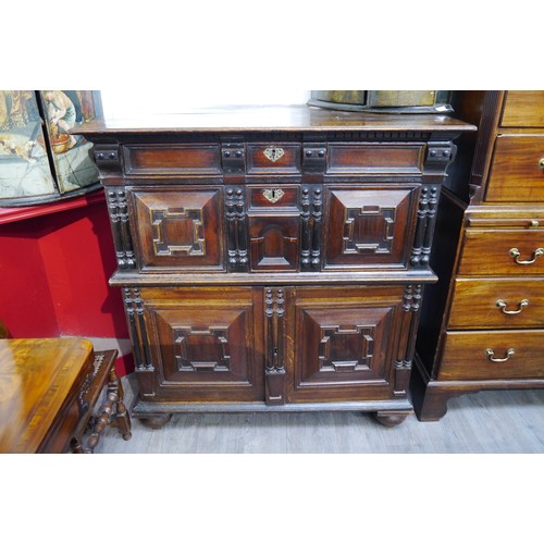 6072 - A Charles II Oak cabinet of drawers late 17th Century. The oak panelled chest over cupboard with dra... 