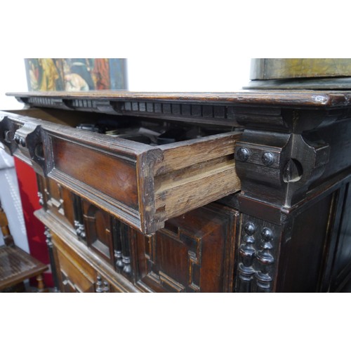 6072 - A Charles II Oak cabinet of drawers late 17th Century. The oak panelled chest over cupboard with dra... 