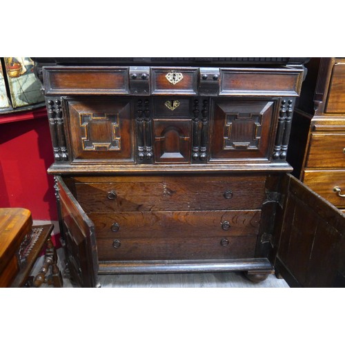 6072 - A Charles II Oak cabinet of drawers late 17th Century. The oak panelled chest over cupboard with dra... 