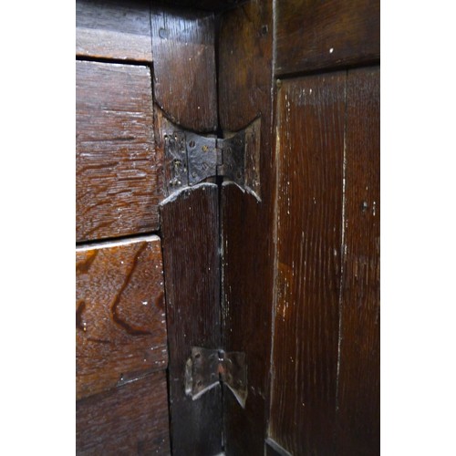 6072 - A Charles II Oak cabinet of drawers late 17th Century. The oak panelled chest over cupboard with dra... 