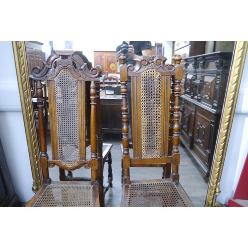 6061 - Two walnut Charles II style hall chairs, cane-backed and seats