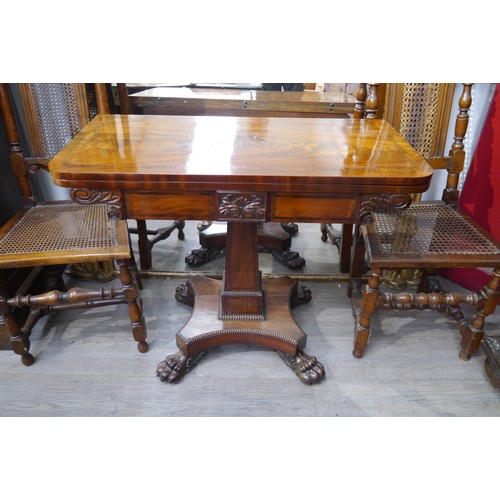 6064 - A 19th Century flame mahogany card table with cross-banded top, over column support to large paw fee... 