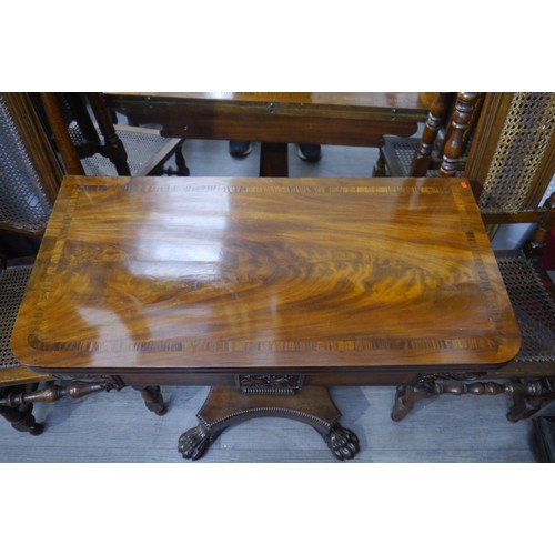 6064 - A 19th Century flame mahogany card table with cross-banded top, over column support to large paw fee... 