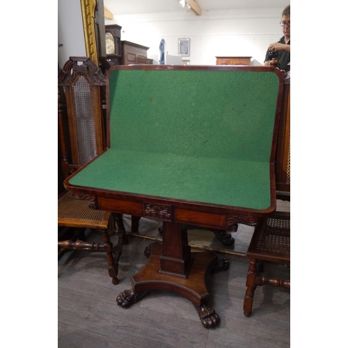 6064 - A 19th Century flame mahogany card table with cross-banded top, over column support to large paw fee... 