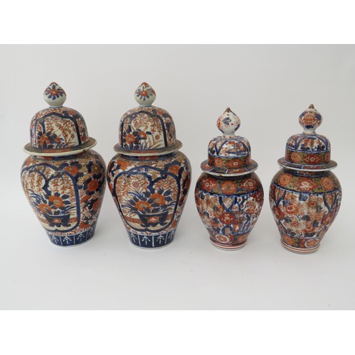 6089 - Two pairs of Japanese Imari lidded vases, 26cm and 31cm tall (4)