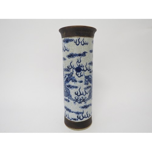 6031 - An early 20th Century Chinese cylindrical vase, dragons chasing the flaming pearl, cracked and resto... 